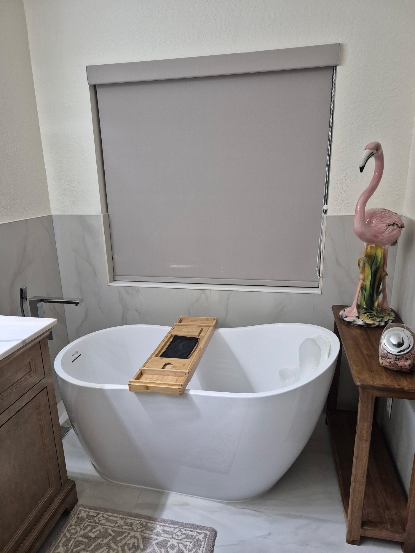 Luxury bathroom with freestanding soaker tub and herringbone tile